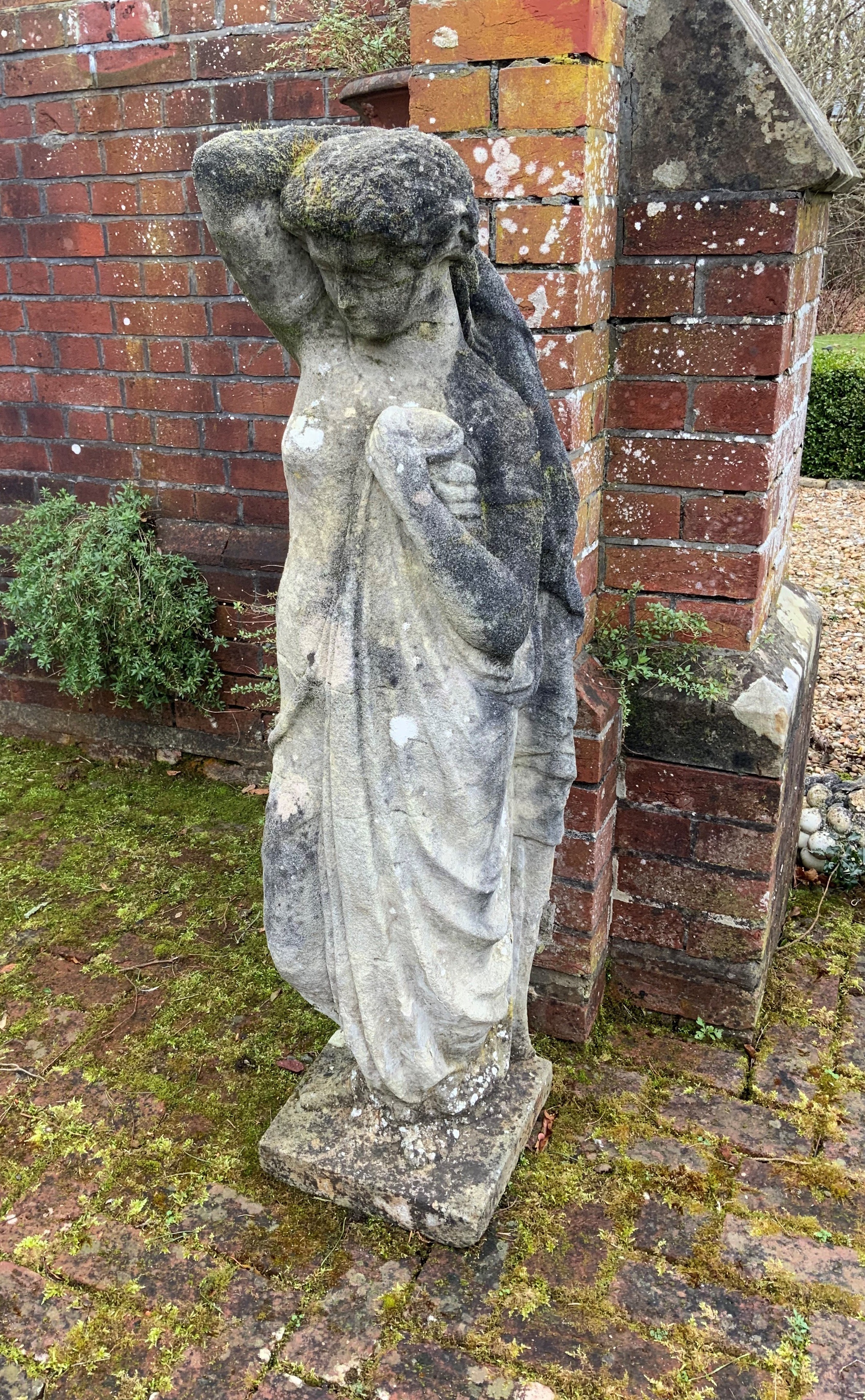 A reconstituted stone figure of Venus, on square plinth, height 130cm